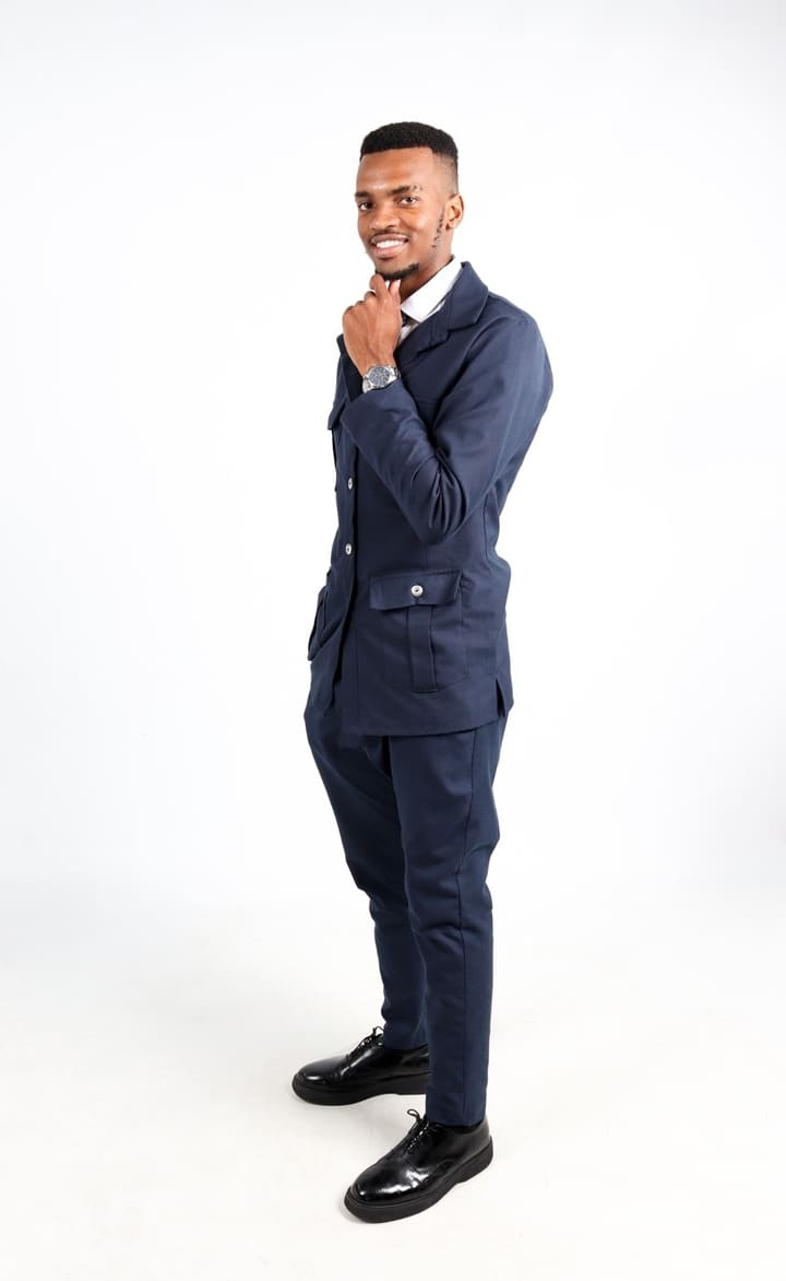 Ntsikayomzi Gidi, Founder and Creative Director of GVisuals, in a full-length portrait.